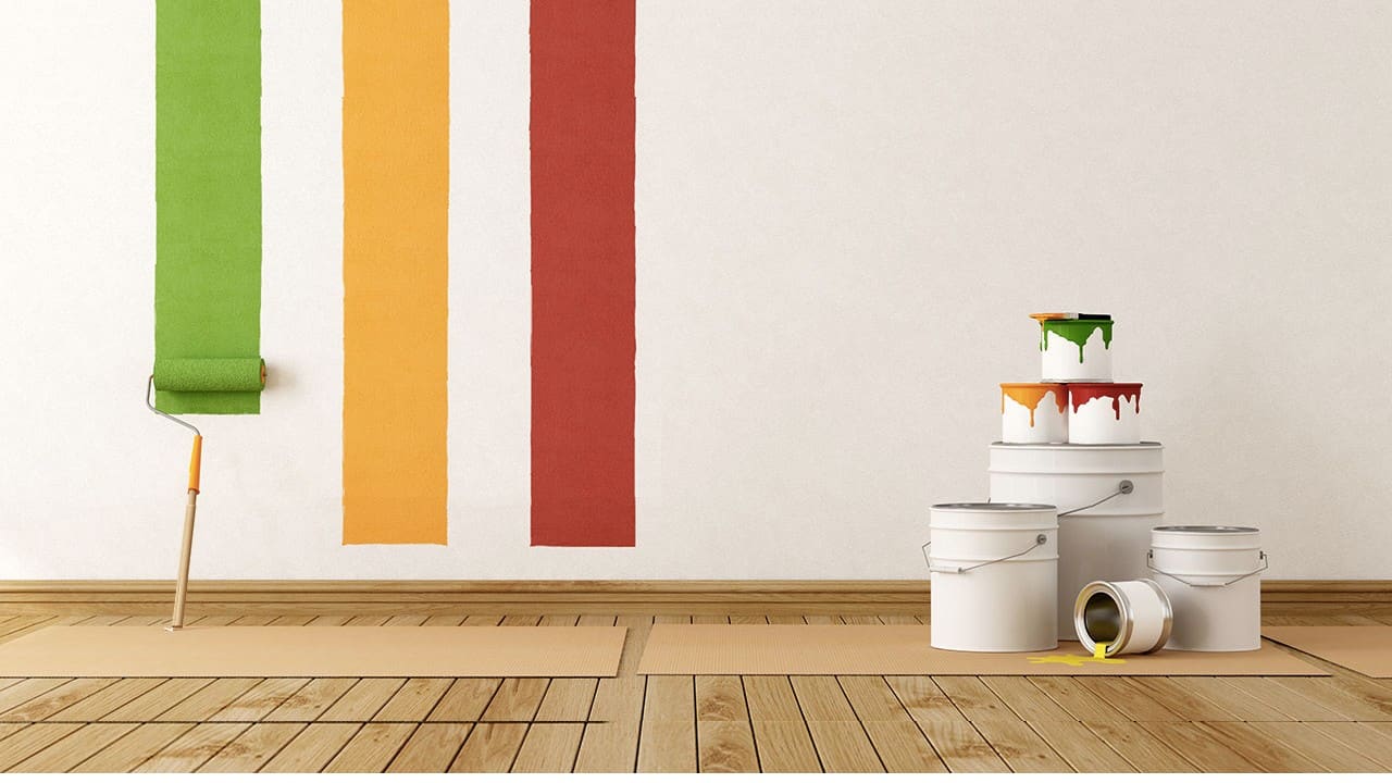 Paint roller and colourful paint stripes with paint tins — professional painters and decorators at Kings Renovations in Hertfordshire