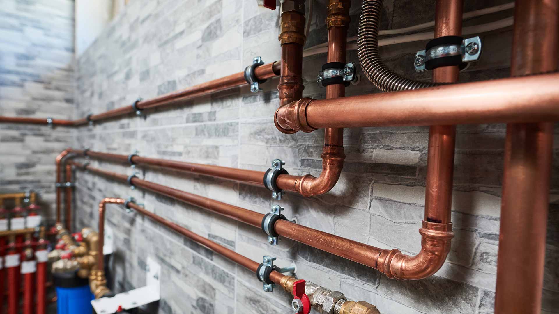 Neat copper pipework installation by professional plumbers at Kings Renovations in Hertfordshire