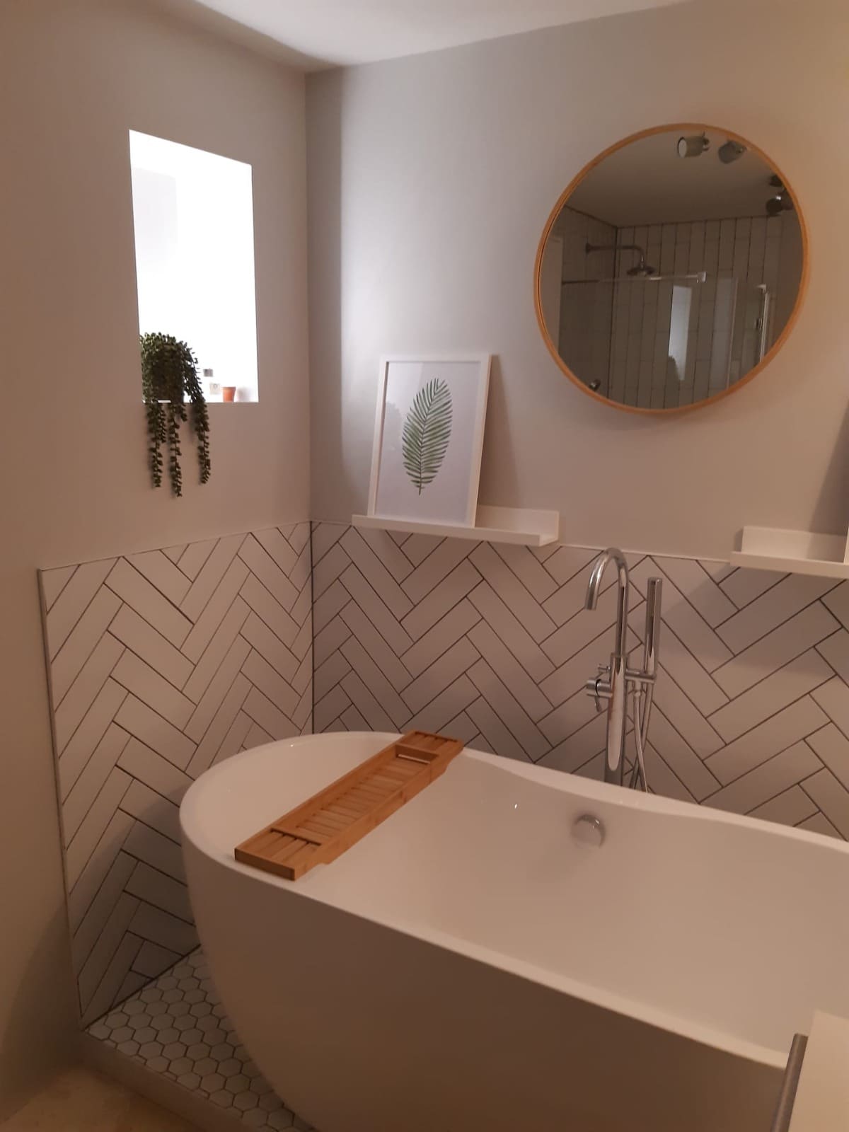 Freestanding bath with herringbone tiles fitted by Kings Renovations bathroom fitters